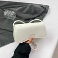 Minimalist white leather underarm bag with knot strap detail and gold fashion lettering - White