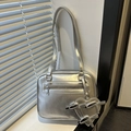 Metallic silver shoulder bag with heart pendant shown in elegant window natural light - With Pendant / Silver