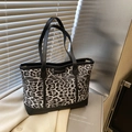 Leopard print tote bag with black leather trim and long handles for shoulder wear - Black