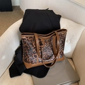 Vintage leopard print tote bag with brown faux leather straps on a white sofa decor - Brown