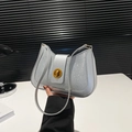 Sparkly silver crescent shoulder bag with a gold twist-lock and sleek leather strap - Silver