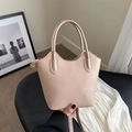 Minimalist beige leather bucket tote bag with dual handles and thin crossbody strap - Khaki