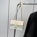 Minimalist beige crossbody bag with gold chain strap and geometric metal buckle detail - Off White