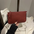 Dark red woven crossbody bag with silver chain strap and top zipper closure - Red