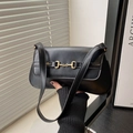 Chic black leather shoulder bag with gold horsebit buckle and minimalist luxury aesthetic - Black