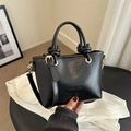 Classic black leather bucket bag with knotted handles and adjustable shoulder strap - Black