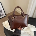 Deep brown faux leather bucket bag with top handle knot and golden hardware - Brown