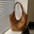 French style matte caramel brown suede tote bag with bow detail in soft natural sunlight - Brown