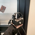 Mini black crescent handbag featuring silver metal studs and removable crossbody strap - Black