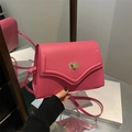 Fashionable vibrant pink leather shoulder bag with gold oval twist lock and slim strap - Rose Pink