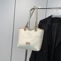 Cream tote bag with khaki trim, decorative knotted straps and fashion leather label - White