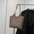 Retro taupe leather tote bag with unique knot shoulder strap and fashion label detail - Brown