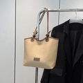 Vintage beige tote bag with brown handles and fashion leather label on metal hanger - Khaki