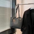 Minimalist black faux leather tote bag with gold hardware and adjustable strap - Black