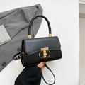 Classic black faux leather handbag featuring a golden T-shaped buckle and top handle - Black