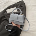 Minimalist light blue crossbody bag with marble texture finish and top handle - Blue