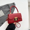 Fashionable red leather handbag with gold T-lock and top handle for women - Red