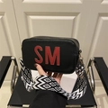 Black leather rectangular crossbody bag with red SM logo and geometric wide strap - Black