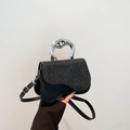 Elegant black saddle bag with shimmering sequins and unique silver metallic handle - Black