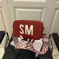 Red leather crossbody bag featuring white SM embroidery and geometric pattern wide strap - Red