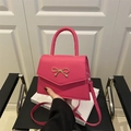 Hot pink crossbody bag with gold bow clasp and sleek leather finish - Rose Pink