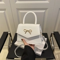 White minimalist crossbody bag for women with golden metal bow and top handle strap - White