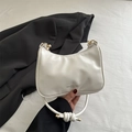 White minimalist PU leather hobo bag with knotted strap and gold hardware accents - White