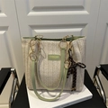 Chic woven cream tote bag with light green handles and decorative hanging knot charm - With Pendant / Green