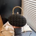 Elegante borsa da sera ovale in tweed nero e oro con manico in metallo intrecciato e catena - Nero