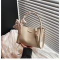 Detail of beige lychee leather bucket bag with fashion embossing and silk scarf - With Silk Scarf / White