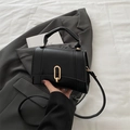 Chic black matte leather square handbag with golden oval metal lock and shoulder strap - Black