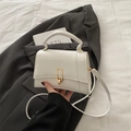 Elegant white square crossbody bag with gold buckle on a stylish grey blazer background - White