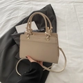 Chic beige textured crossbody handbag with knot handle and golden hardware details - Khaki