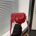 Red lychee texture leather saddle bag with golden metal swivel lock and slim strap - Red