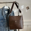 Deep brown retro PU leather tote bag with wide strap and magnetic buckle on denim background - Brown
