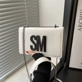 Minimalist white leather crossbody bag featuring bold black SM lettering and chain strap - White