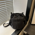 Minimalist black nylon bucket bag with drawstring closure and fashion label detail - Black