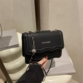 Minimalist black lychee leather crossbody bag with silver chain and wave flap detail - Black