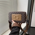 Brown vintage monogram crossbody bag with embossed G logo and wide nylon strap - Khaki