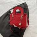 Elegant red quilted square handbag with silver ball charm and crossbody strap - Red
