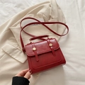 Structured dark red faux leather handbag with gold round buckle and crossbody strap - Red