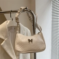 White woven baguette bag with metal butterfly clasp and pleated shoulder strap design - White