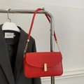 Red crocodile pattern square shoulder bag with gold hardware on a display hanger - Red