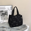 Black corduroy tote bag featuring a cute smile bear print and top zipper closure - Black
