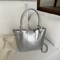 Chic silver crossbody bucket bag with metallic finish and gold hardware accents - Silver