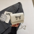 Creamy white crossbody bag with silver metal bow detail and thin chain strap - Off White