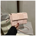 Close-up of pink woven texture crossbody bag with marble pattern and silver hardware - Pink