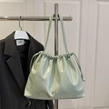 Chic mint green pleated bucket bag with drawstring closure and silver bow charm - Green