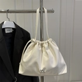 Elegant cream white drawstring shoulder bag with a delicate silver bow metal buckle - White