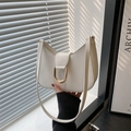 Minimalist white semi-circle hobo shoulder bag with a gold horseshoe buckle accent - White